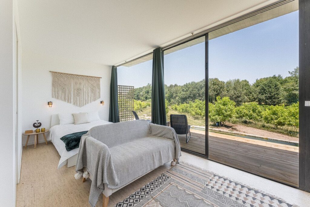 Quarto do Retiro com a parede de vidro virada para o pomar